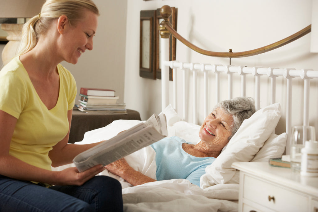 Bedtime comfort and safety for seniors as daughter reads to elderly mother