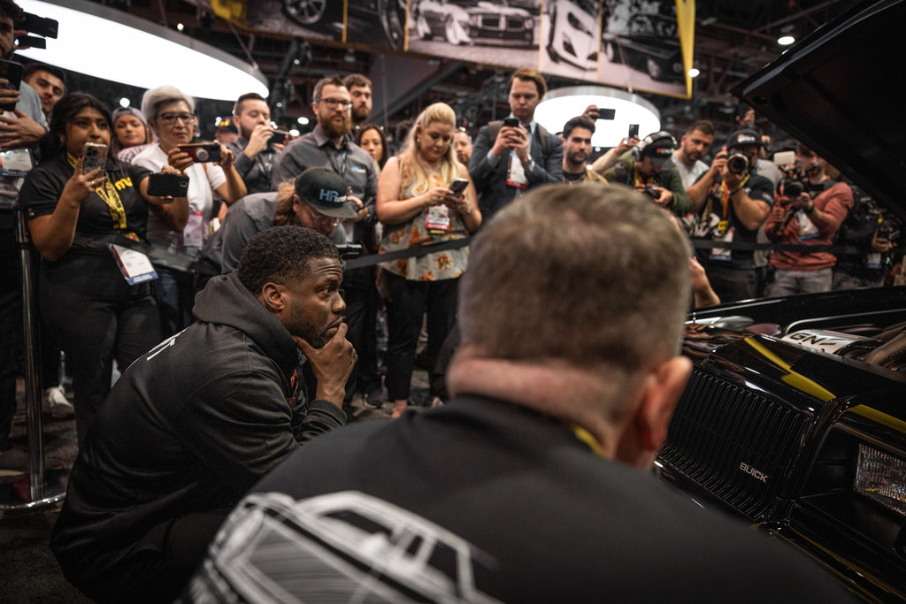 Kevin Hart admiring The Dark Knight unveiling at the MagnaFlow SEMA 2022