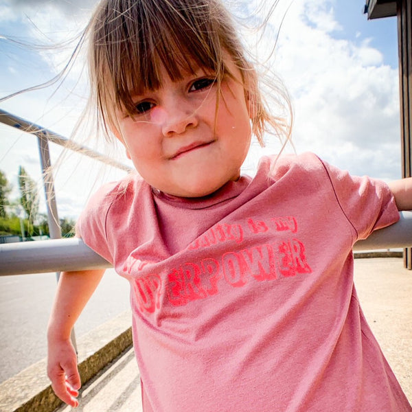 Mauve kids unisex tee with the my personality is my superpower in glow pink ink.