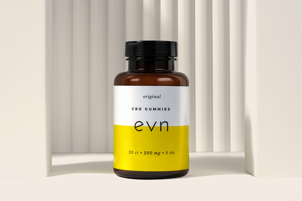 A bottle of 200mg EVN CBD Oil on a whitish surface 