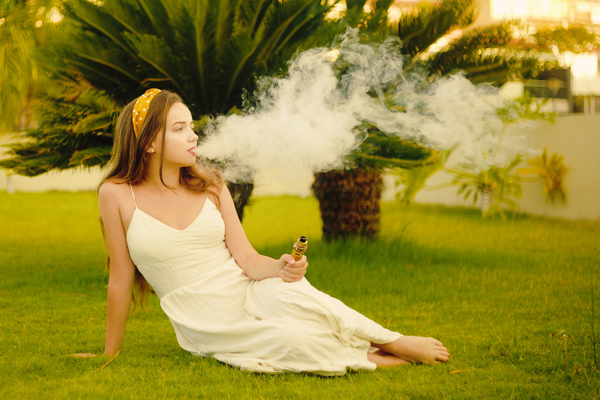 a woman vaping cannabis