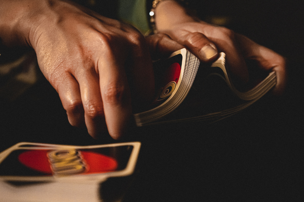 hands shuffling uno cards