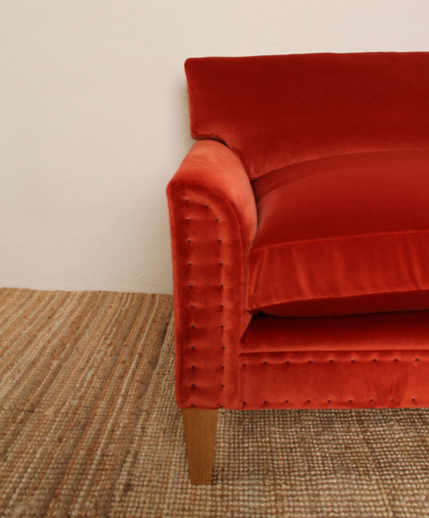 Bespoke orange sofa with small nail detailing