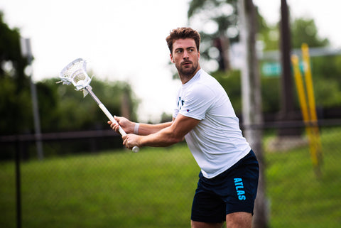 Jake Caraway, ECD Pro and member of the PLL, shooting a lacrosse shot wearing his Atlas LC lacrosse apparel.