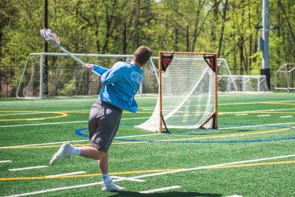 Professional lacrosse player, Bryce Wasserman shooting a lacrosse ball with an ECD lacrosse stick