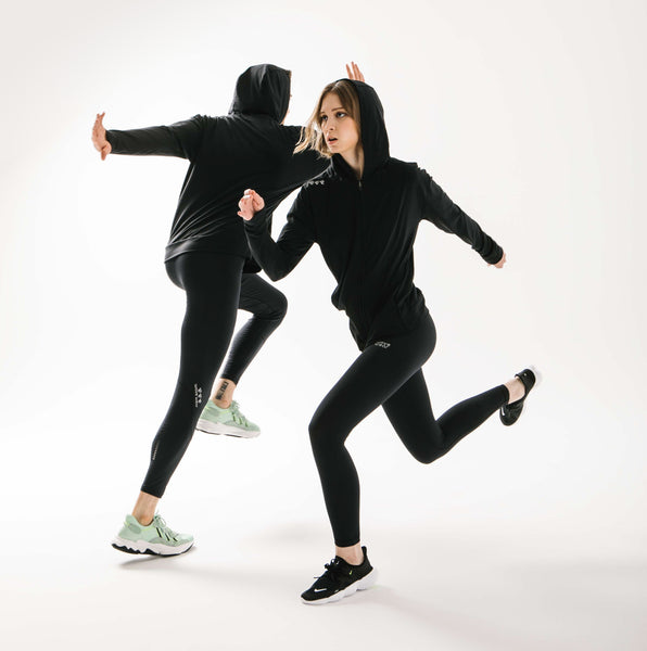 action shot of two models wearing wavewear compression leggings