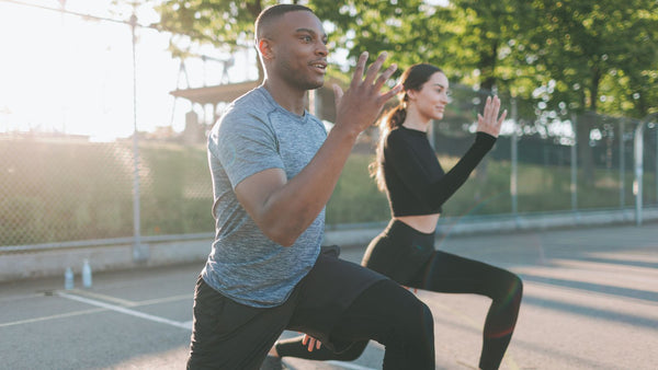 two models mid run wearing athletic wear out on a black top