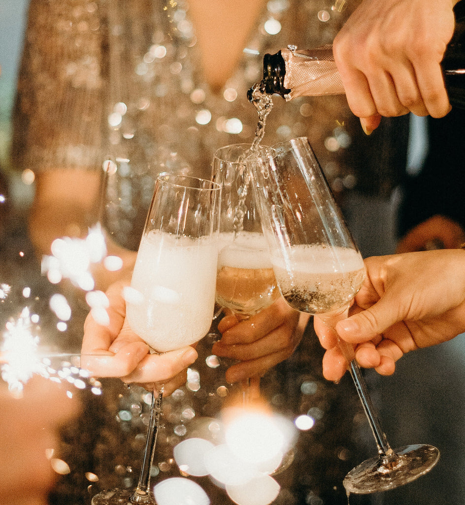 Woman pouring champagne in glasses