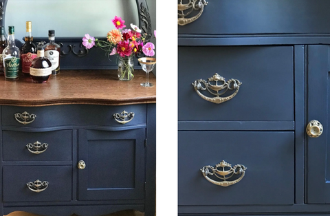 an image of a vanity that has been painted navy blue with a wooden bench top, styled with fresh orange and pink flowers and a selection of upmarket gins