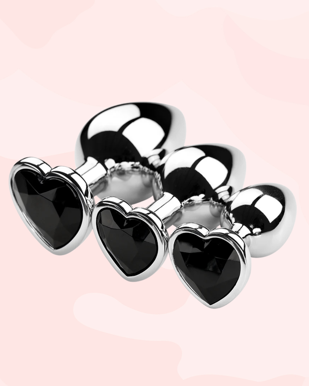 Elegant black heart-shaped anal plugs with shiny silver accents