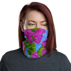 Woman wearing a knit fabric neck gaiter /face cover with a colorful floral painting, by fine artist Nancy McLennon, printed on the fabric