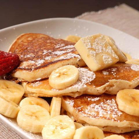 Pancakes with maple butter, bananas and strawberries