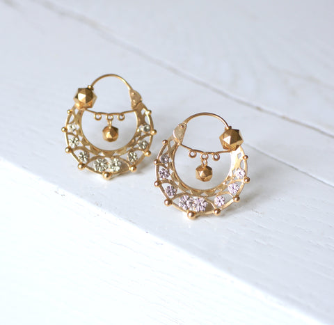 Earrings evolved from the simple diamond studs or sleepers that were seen at the beginning of the period to more ornate creations in platinum and diamonds. Earrings also took on many of the popular motifs and techniques at the time such as garland-style wreaths, millegrain, and openwork designs. In line with the trend for movement, long dangly drop earrings were also very fashionable.