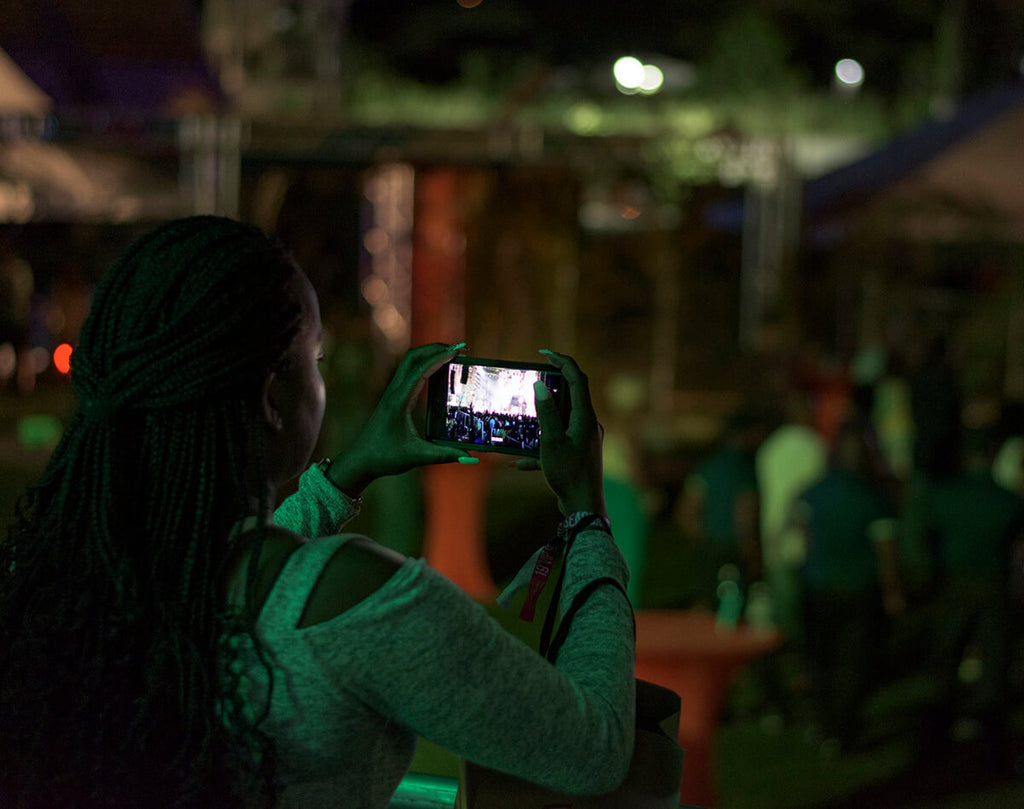 Patron in the VIP area recording the scene on stage, WCMF 2019