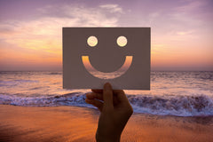 smiling pace in paper at beach