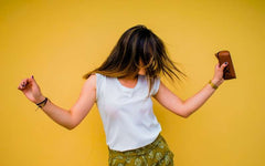 Woman dancing on yellow background