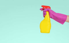 Cleaning spray bottle yellow on turquoise background