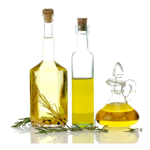 Three bottles of oil on a white background