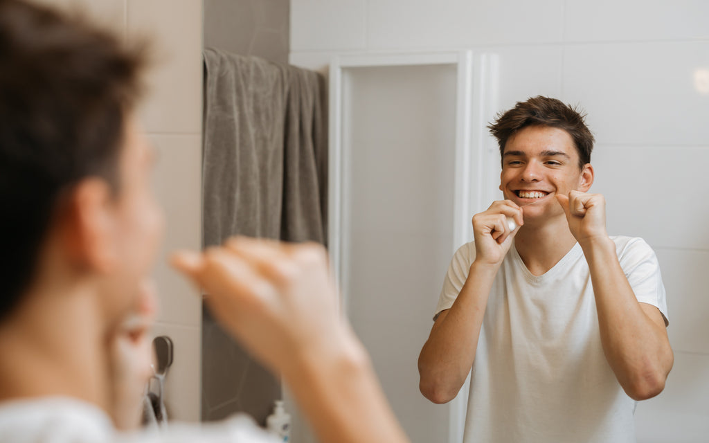 man using dental floss