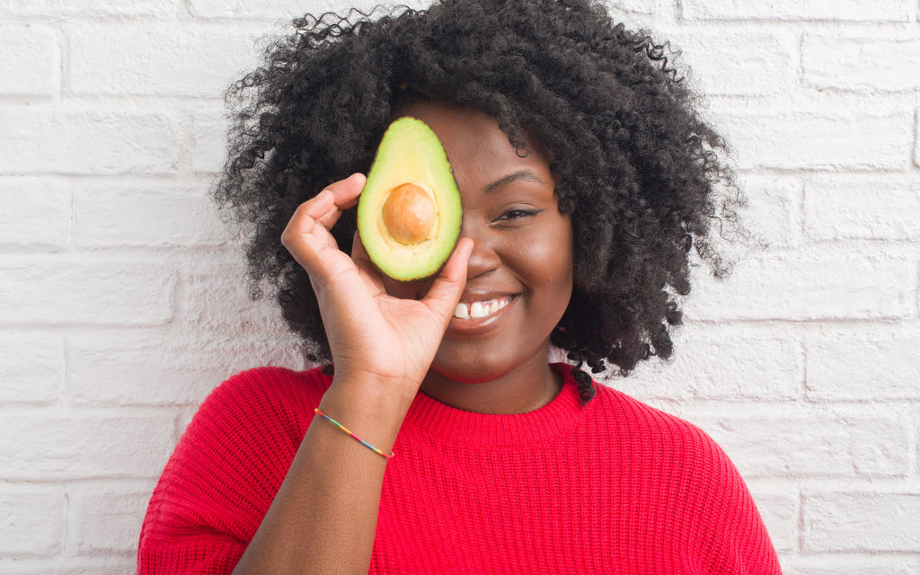 girl holding an avocado