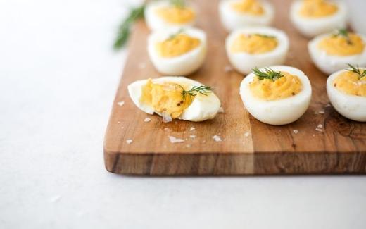Keto Dill Stuffed Eggs in a wooden board