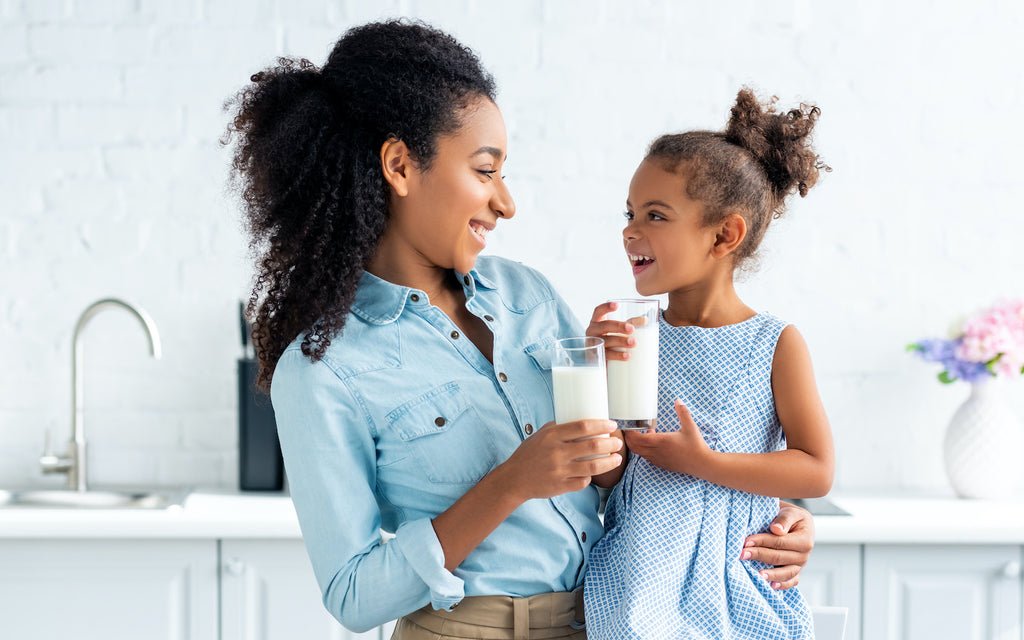 milk on keto: woman and a girl holding a glass of milk