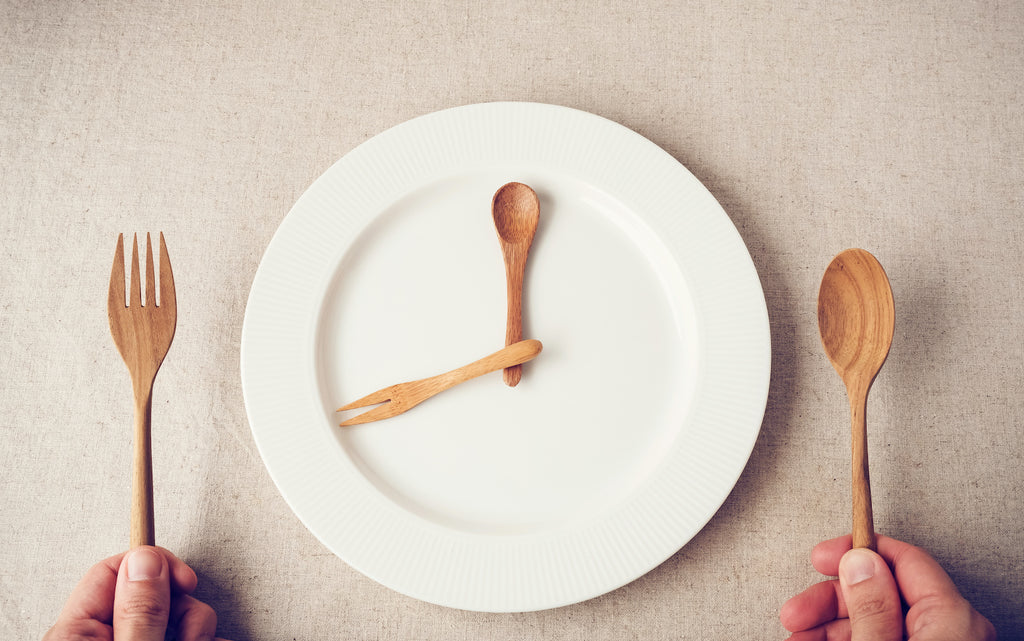 what breaks a fast: White plate with wooden spoon and fork