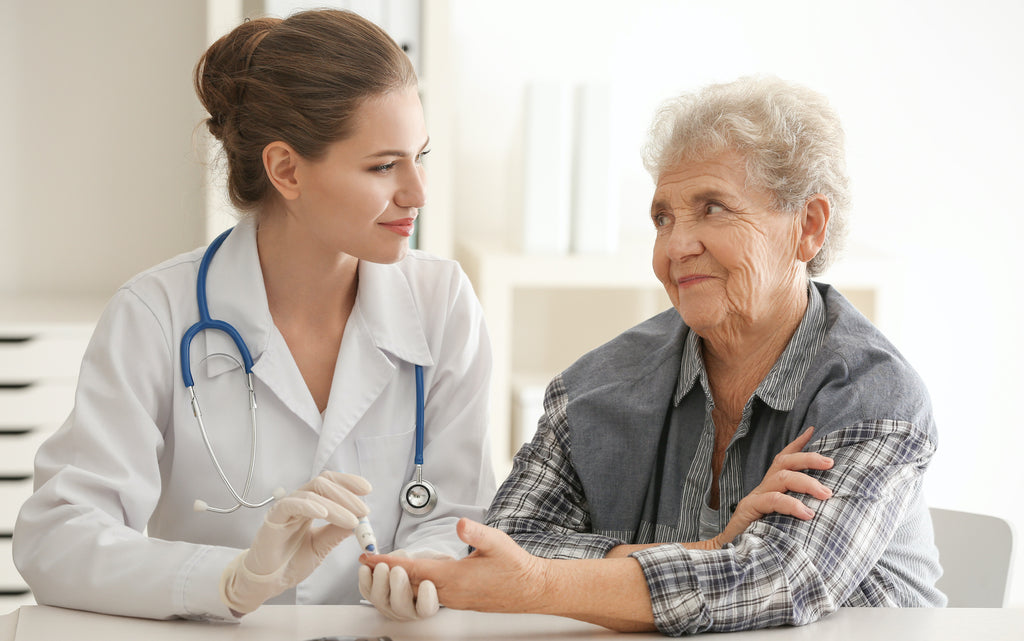 Doctor measuring blood sugar level of a patient