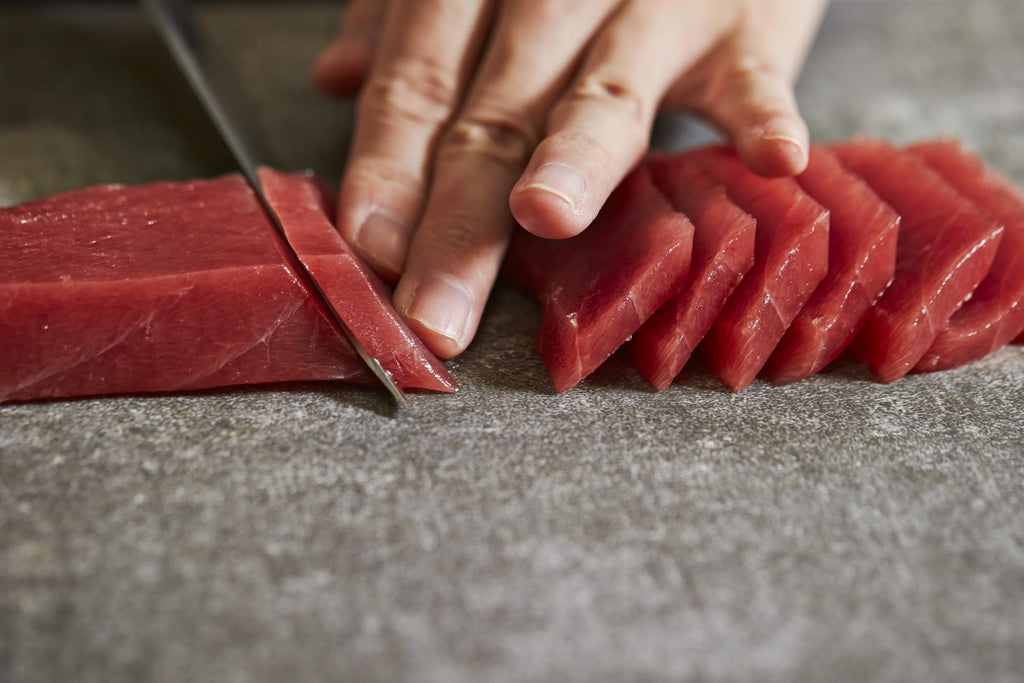 Carnivore diet recipes: Cutting raw meat using a knife