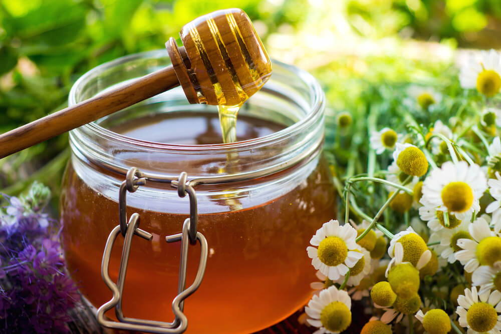 jar of honey placed outdoors