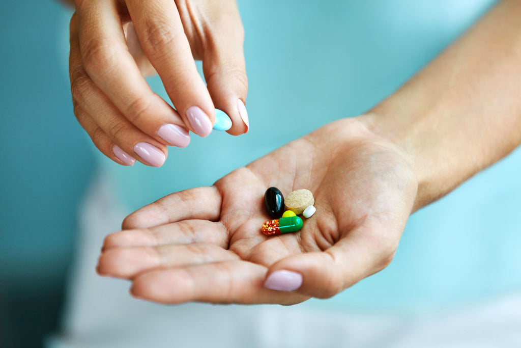Do vitamins break a fast: various pills in a hand