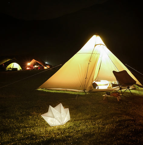 solar camping light design. QWNN solar lantern lights up a campsite.