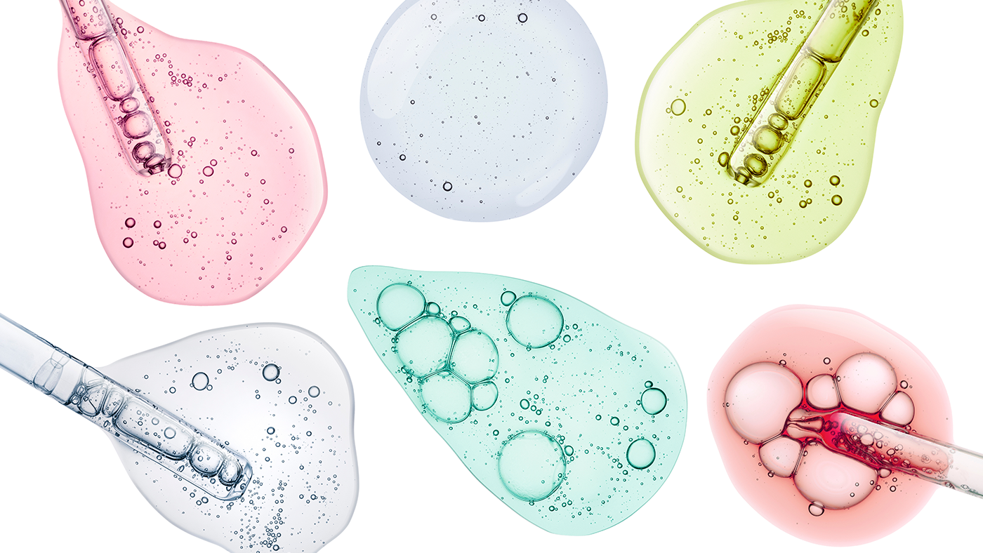 A collection of serums and pipettes on a white backdrop in various colours