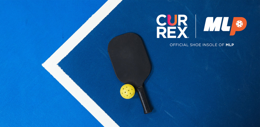 pickleball paddle and pickleball on pickleball court