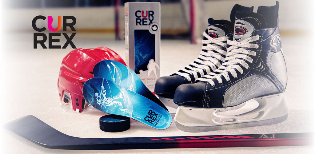 Pair of skates, hockey insoles, and hockey equipment on ice