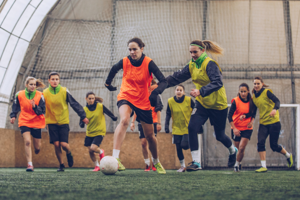 Group of women playing indoor soccer