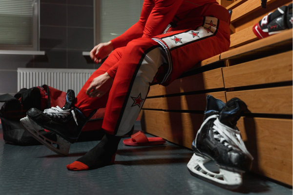 Hockey player putting on hockey skates