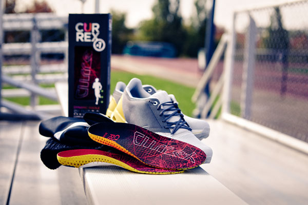 red running shoe insoles with running shoes on bleachers