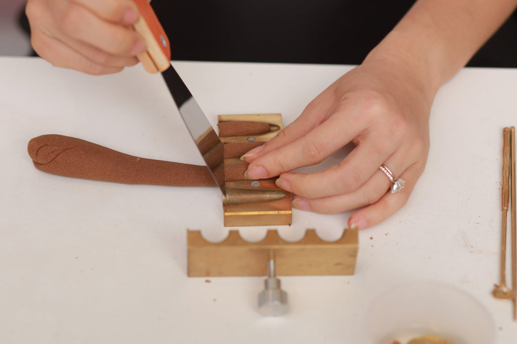 Putting incense dough into the incense cone mold