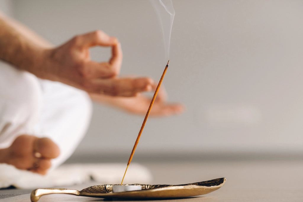 Meditating with a burning incense