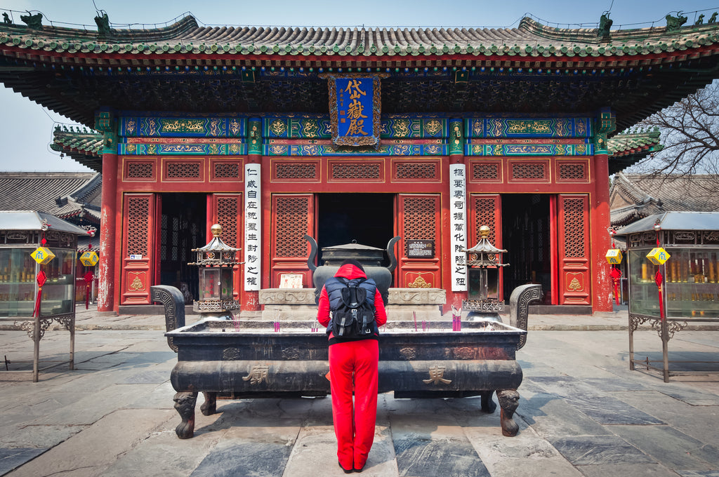 A large incense burner in front of a Beijing Temple