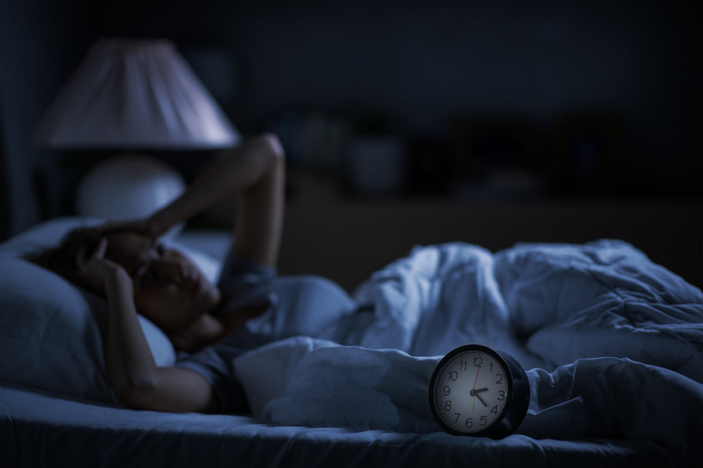 Woman suffering from insomnia in bed