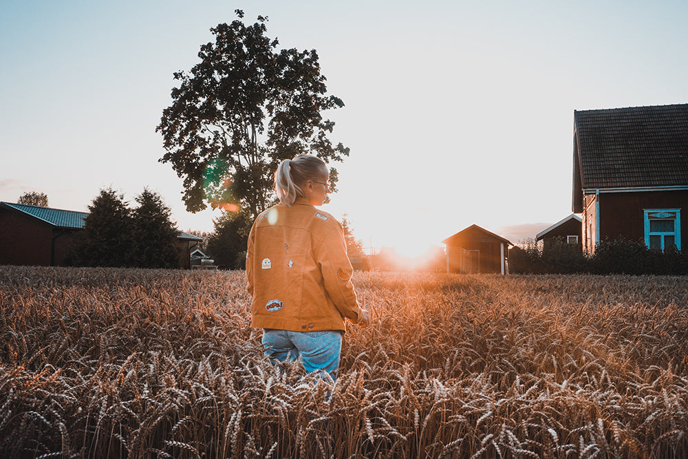 A Finnish girl on a field on an autumn evening at sunset