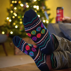 Christmas socks being worn in front of the tree whilst drinking a can of Thornbridge Beer