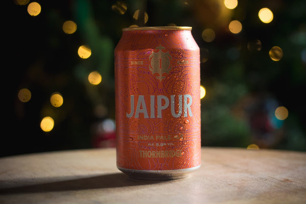 Jaipur Can in front on a sparkling Christmas Tree