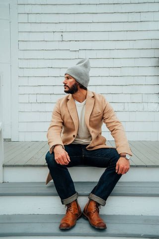 Stylish Male Model With Nacked Torso In Black Clothes. Posing Sit Down On  The Floor, Looking At Camera, Isolated On A White Background. Stock Photo,  Picture and Royalty Free Image. Image 123183019.