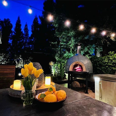 Forno Piombo Pizza Oven Backyard with Flowers_night