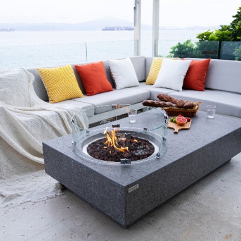 Metropolis light gray fire table with flame, & wind guard, sofas & sea