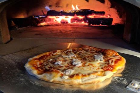 Pizza with flames in CBO Pizza Oven