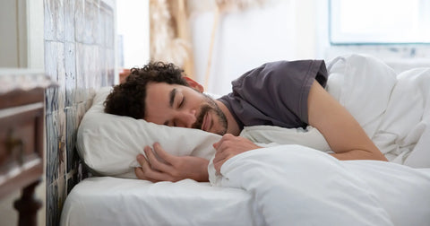 A cozy sleeping arrangement depicting a man resting comfortably with his bed, ensuring a calming and restorative sleep experience.